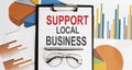 Support Local Business text . Conceptual background with chart ,papers, pen and glasses, business concept