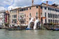Support by Lorenzo Quinn. Gigantic hands rise from water to support the Ca Sagredo Hotel