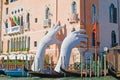 `Support` - the modern sculpture of Lorenzo Quinn on the Grand Canal on a sunny afternoon, Venice
