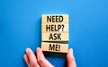 Support and need help ask me symbol. Concept words Need help ask me on wooden blocks on a beautiful blue table blue background. Royalty Free Stock Photo