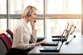 Support phone operator in headset at workplace. Royalty Free Stock Photo