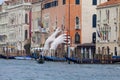 Support Sculpture by Lorenzo Quinn putting two giant hands protruding from the Grand Canal water, Venice, Italy