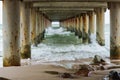The support of the sea promenade, under the bridge, the sea water under the pier Royalty Free Stock Photo