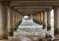 The support of the sea promenade, under the bridge, the sea water under the pier Royalty Free Stock Photo