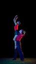 Support. Sensual young dancers dancing ballroom dance isolated on dark background. Concept of art, dance, beauty, music