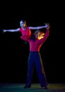 Support. Sensual young dancers dancing ballroom dance isolated on dark background. Concept of art, dance, beauty, music
