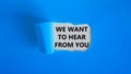 Support symbol. Concept words `we want to hear from you` appearing behind torn blue paper. Beautiful blue background. Business a Royalty Free Stock Photo