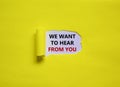 Support symbol. Concept words `we want to hear from you` appearing behind torn yellow paper. Beautiful yellow background. Busine