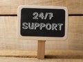 Support 247 text write on Chalkboard at wooden background