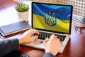 Support Ukraine, donate help Ukrainian people. Flag on computer laptop screen. 3d render