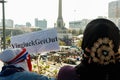 A supporter of People\'s Alliance for Democracy, PAD, shows a protest sign against Yingluck Shinawatra.