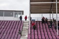 Supporters leaving halft empty seats and tiers of Dan Paltinisanu stadium of timisoara, after to a cancelled match due to snow