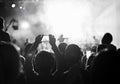 Supporters recording at concert, black and white