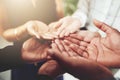 Supporting each other. Closeup shot of a group of businesspeople standing with their hands cupped together.