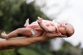 Supporting Hands. Father holding his 14 days old baby girl on his arms Royalty Free Stock Photo