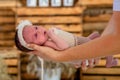 Supporting Hands. Father holding his 14 days old baby girl on his arms