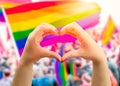 Heart sign and wave in front of a rainbow flag Royalty Free Stock Photo