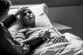 supporting sad, dying woman with tumor in a hospital, black and white photo