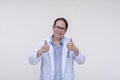 A supportive family doctor gives a double thumbs up sign. Giving his approval. Of asian descent, middle aged male in his 40s.