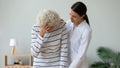 Supportive female caregiver help unhealthy senior patient