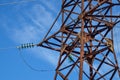 Supports high-voltage power lines against the blue sky with clouds. Electrical industry Royalty Free Stock Photo