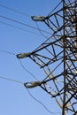 Supports high-voltage power lines against the blue sky. Electrical industry. Royalty Free Stock Photo