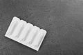 Suppositories and space for text on background, top view. Hemorrhoid treatment Royalty Free Stock Photo