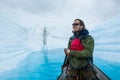 Happy man excited to paddle a canoe on a supraglacial lake on the Matanuska Glacier