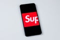 Supreme app logo on a smartphone screen.