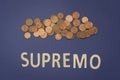 Supremo written with wooden letters on a blue background Royalty Free Stock Photo