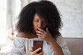 Suprized shocked woman looking at smartphone screen watching strange weird funny photo or video