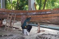 Young woman marine engineering student making a wooden boat