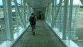 Surabaya, Indonesia; january 2023-Passengers walk through the aisle leading to the plane for boarding