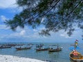 Surabaya, Indonesia - March 2, 2021 : Lovely view with boats, tree, and great sky in the picture.