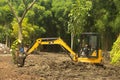 A Worker on modern excavator performs excavation work on the construction site, a Park in Keputih Surabaya. Royalty Free Stock Photo