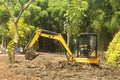 A Worker on modern excavator performs excavation work on the construction site, a Park in Keputih Surabaya. Royalty Free Stock Photo