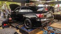 Black Subaru WRX STI on dyno to measure the engine power