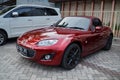 Red Mazda MX-5 Miata roadster on parking lot