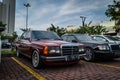 Wine red coloured Mercedes Benz 230 W123 on parking lot