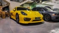 Yellow Porsche Cayman inside a garage