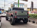 Green Hummer H2 SUT on traffic jam