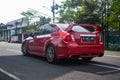 Red Subaru WRX STI sedan leaving JDM run car meet Royalty Free Stock Photo