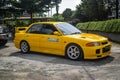 Yellow Mitsubishi Lancer evolution III leaving JDM run car meet Royalty Free Stock Photo