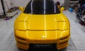 Yellow Honda NSX NA1 in a car detailing shop