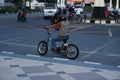 Surakarta, Indonesia - September 1, 2021: A tourist is riding a unique bicycle that looks like a motorbike in front of the Surakar