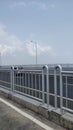 Suramadu bridge is a beautiful bridge with guardrails and cars passing through the road