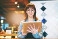 It sure is a breeze to manage business online. a young business owner using a digital tablet in her cafe. Royalty Free Stock Photo