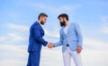 Sure sign you should trust business partner. Men formal suits shaking hands blue sky background. Entrepreneurs shaking