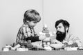 Surefire ways to bond with your son. Dad and kid build plastic blocks. Child care development and upbringing. Father son Royalty Free Stock Photo