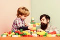 Surefire ways to bond with your son. Dad and kid build plastic blocks. Child care development and upbringing. Father son Royalty Free Stock Photo